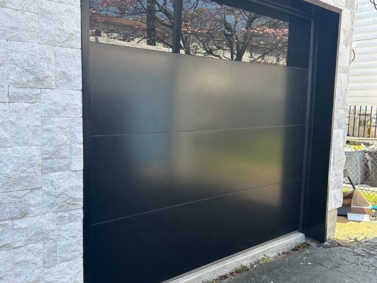 Black C.H.I. Sterling garage door with a glass top section installed by NJ Garage in Elmwood Park, NJ