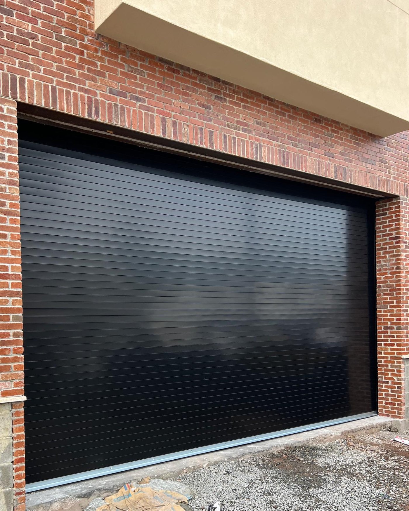 Black rolling gate installed by NJ Garage