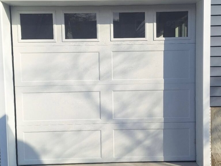 White carriage-style garage door with top window panels