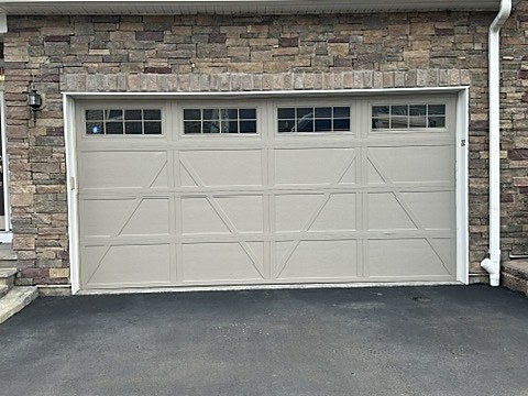 Almond crossbuck carriage-house door installed by NJ Garage in Montvale, NJ