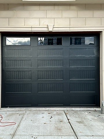 Black door with window row installed by NJ Garage in Guttenberg, NJ