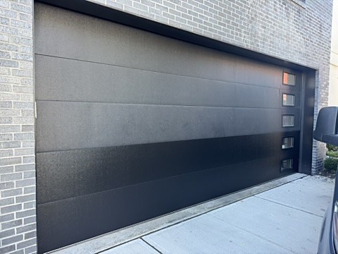 Black flush door with side windows installed by NJ Garage in North Bergen, NJ
