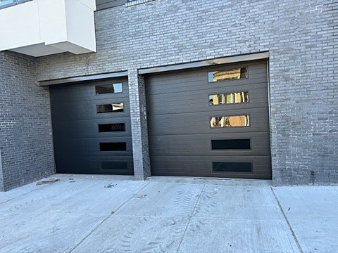 Black flush doors with side windows installed by NJ Garage in North Bergen, NJ