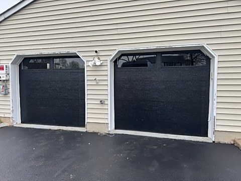 Black garage doors with windows installed by NJ Garage in Piscataway, NJ