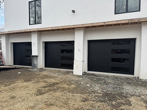 Black modern doors on new construction installed by NJ Garage in Franklin Lakes, NJ
