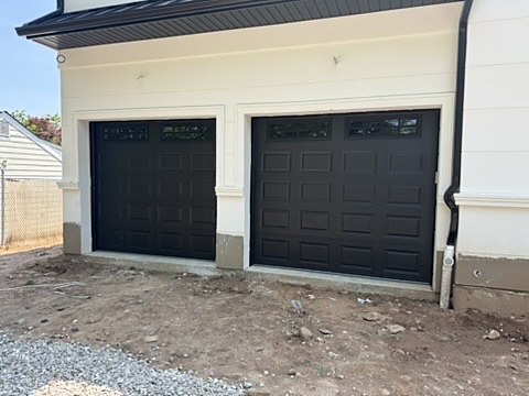 Black raised-panel doors with windows installed by NJ Garage in Paramus, NJ