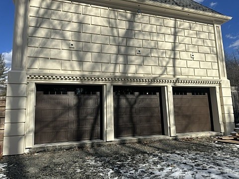 Brown carriage-house doors installed by NJ Garage in Alpine, NJ