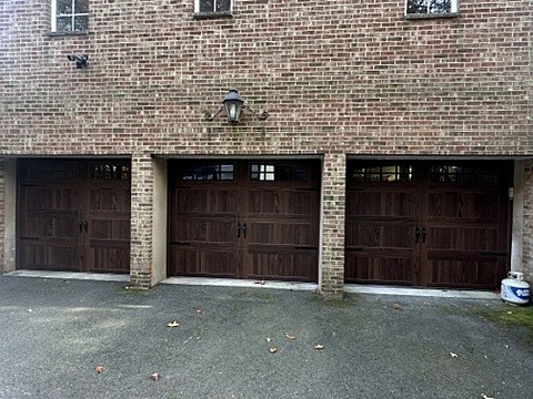 Dark woodgrain carriage-house doors installed by NJ Garage in Westfield, NJ