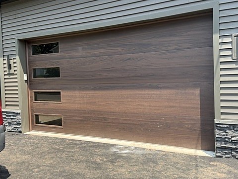 Walnut-look flush door with side windows installed by NJ Garage in Scotch Plains, NJ