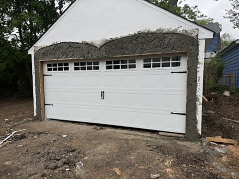 White carriage-house door with hardware installed by NJ Garage in Maplewood, NJ