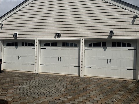 White carriage-house doors with arched windows installed by NJ Garage in Montvale, NJ