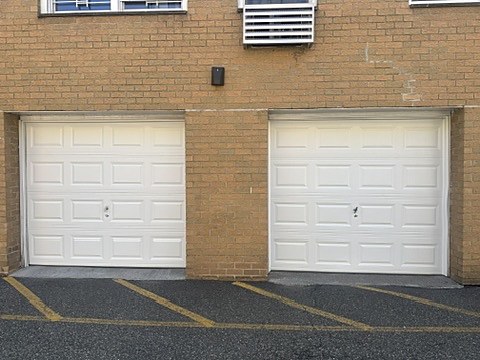 White raised-panel doors on a commercial building installed by NJ Garage in Secaucus, NJ