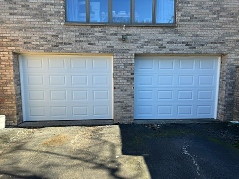 White raised-panel doors installed by NJ Garage in Ridgefield, NJ