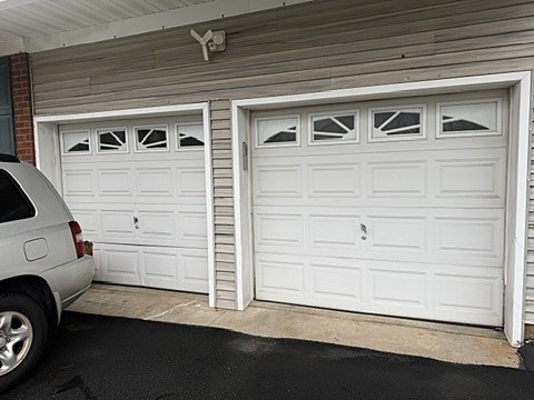 White raised-panel doors with sunburst windows installed by NJ Garage in Rockaway, NJ