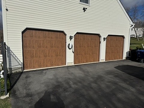 Woodgrain arched-top garage doors installed by NJ Garage in Denville, NJ